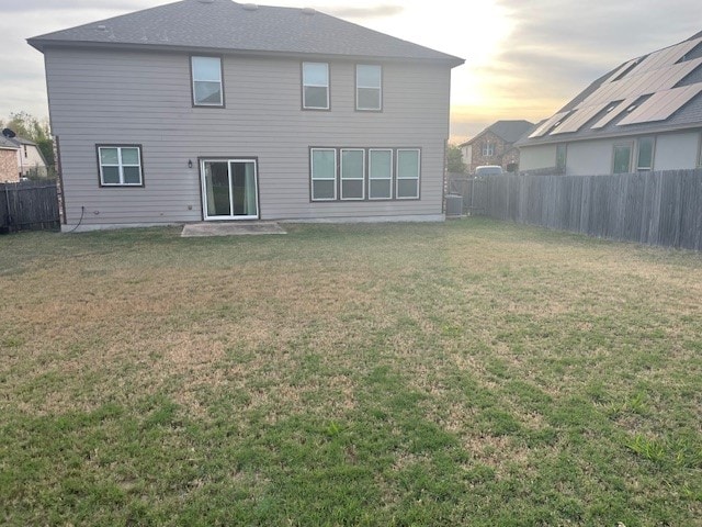 back house at dusk with a yard