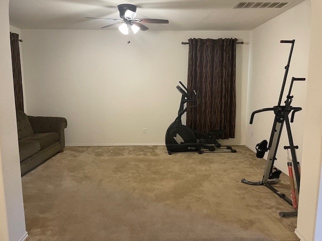 workout area with ceiling fan and carpet