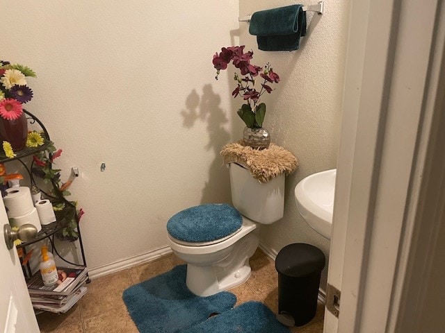 bathroom featuring tile patterned floors and toilet