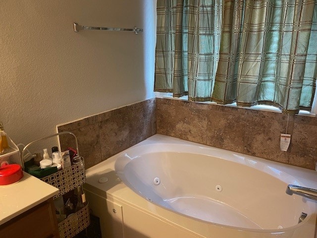 bathroom with a bathtub and vanity