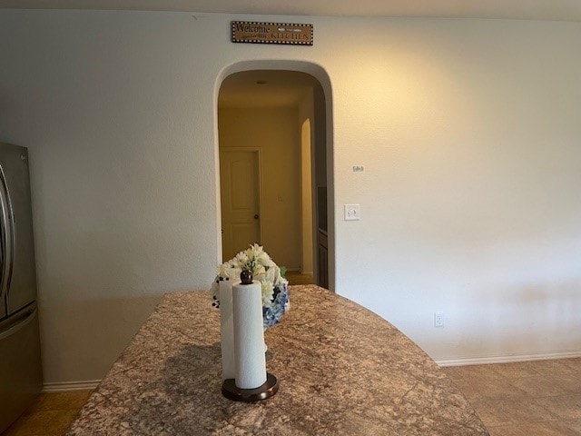 interior space featuring stainless steel refrigerator