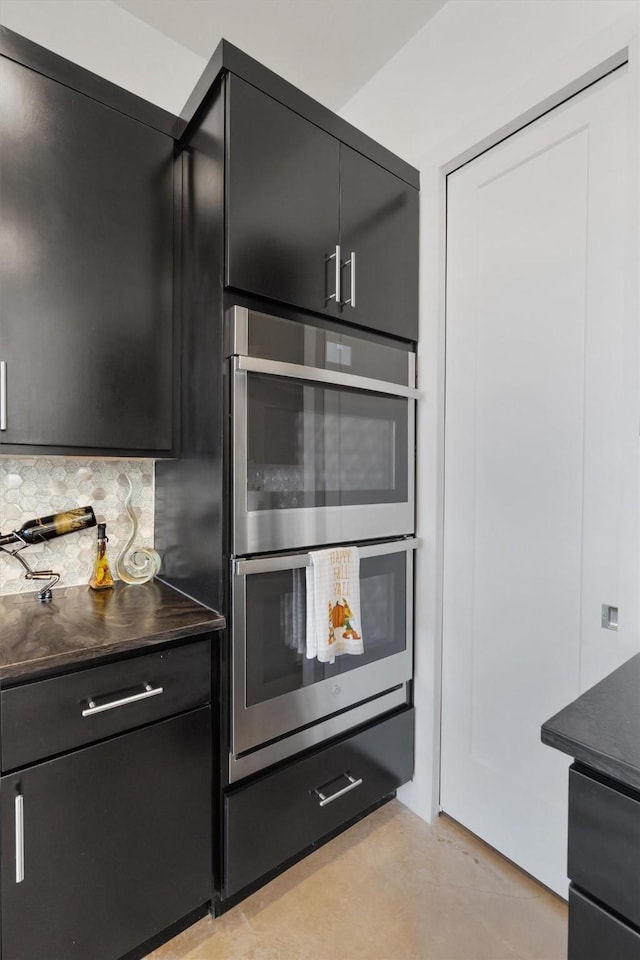 kitchen featuring double oven and decorative backsplash