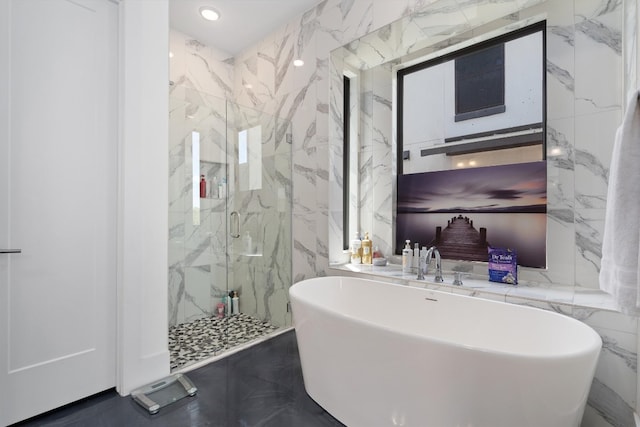 bathroom featuring shower with separate bathtub and tile walls