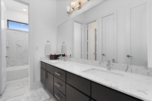 bathroom featuring vanity and tiled shower / bath