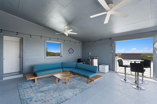 living room featuring vaulted ceiling and ceiling fan