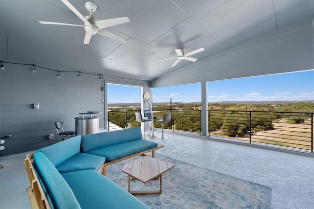 interior space with ceiling fan and lofted ceiling