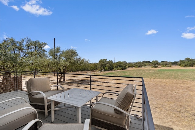 wooden deck with a rural view