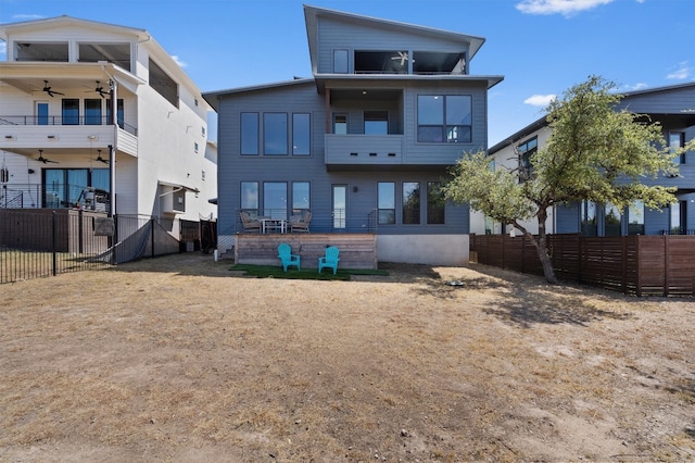 rear view of property with ceiling fan