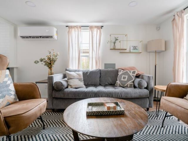 living room with an AC wall unit