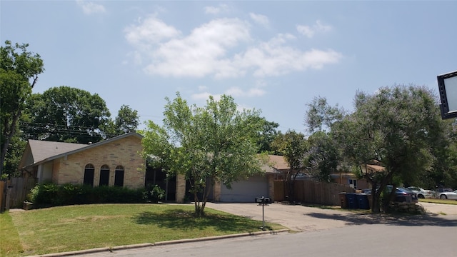 single story home featuring a garage and a front lawn