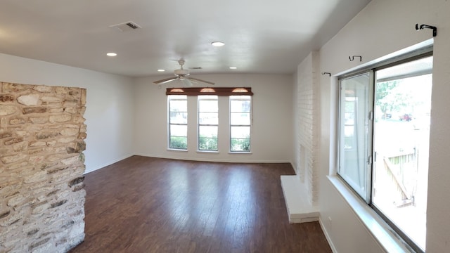 unfurnished living room with ceiling fan and dark hardwood / wood-style floors