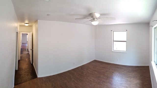 spare room with dark hardwood / wood-style floors and ceiling fan