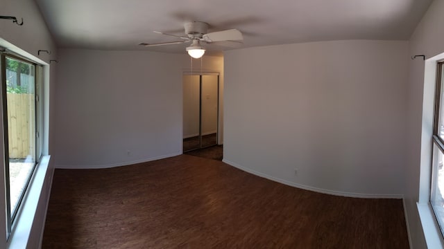 empty room featuring ceiling fan and dark hardwood / wood-style flooring