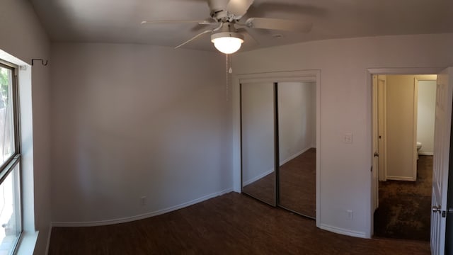 unfurnished bedroom with ceiling fan, a closet, and dark hardwood / wood-style floors