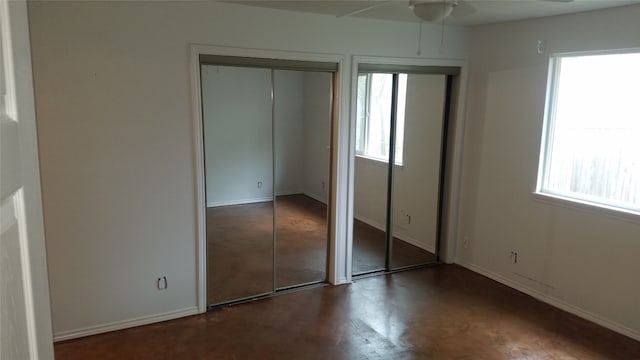 unfurnished bedroom with ceiling fan and multiple windows