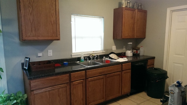 kitchen featuring dishwasher, light tile patterned flooring, and sink