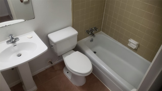 bathroom with tile patterned flooring, tiled shower / bath, and toilet