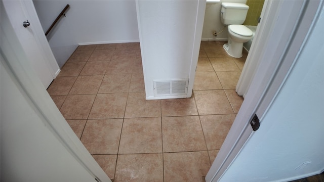 bathroom with tile patterned flooring and toilet