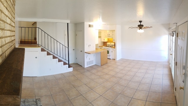 unfurnished living room with ceiling fan and light tile patterned floors