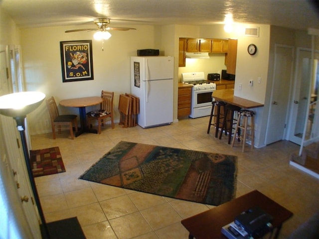 living room featuring light tile patterned floors and ceiling fan