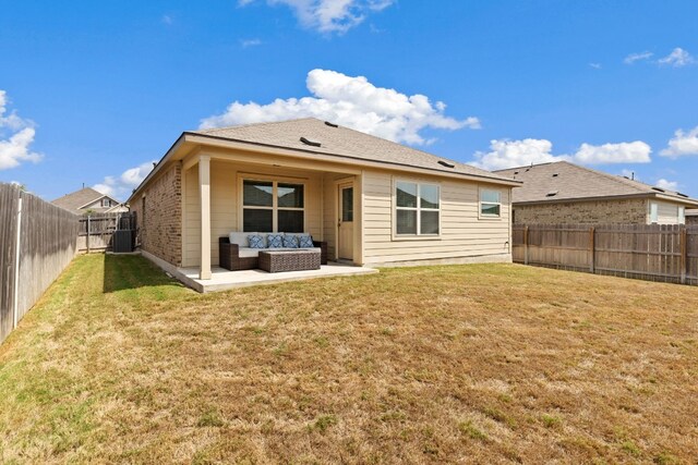 back of property with a lawn, an outdoor living space, a patio area, and central air condition unit