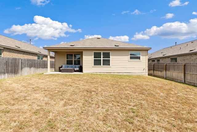 rear view of house featuring outdoor lounge area, a patio area, and a yard