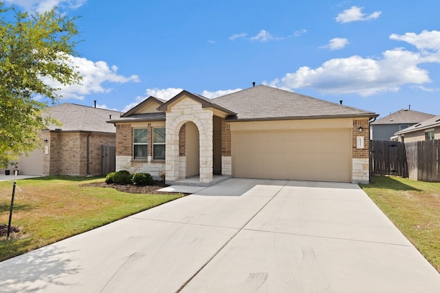 ranch-style home featuring a front yard and a garage