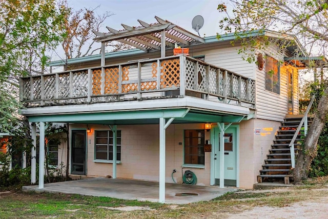 back of property with a pergola and a patio