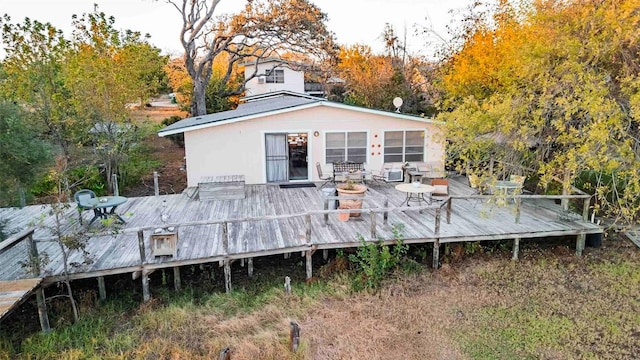 back of house with a wooden deck