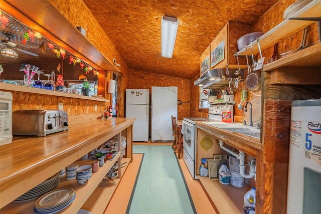 kitchen with sink, water heater, butcher block countertops, lofted ceiling, and white appliances