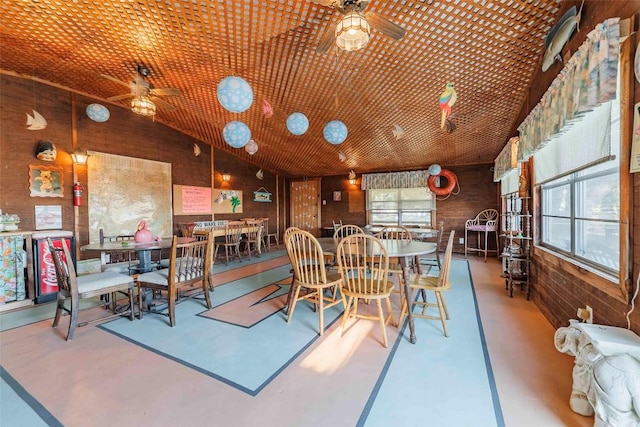 dining area featuring wooden walls, vaulted ceiling, plenty of natural light, and wooden ceiling