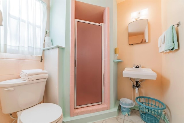 bathroom featuring toilet and an enclosed shower