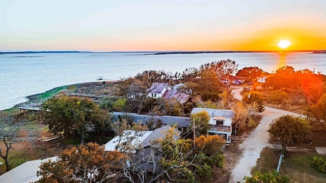 aerial view at dusk with a water view