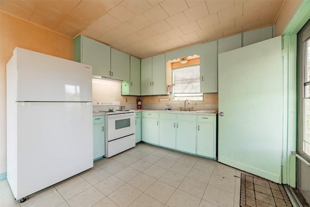 kitchen featuring white appliances and sink