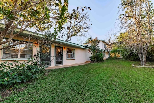 rear view of house with a lawn