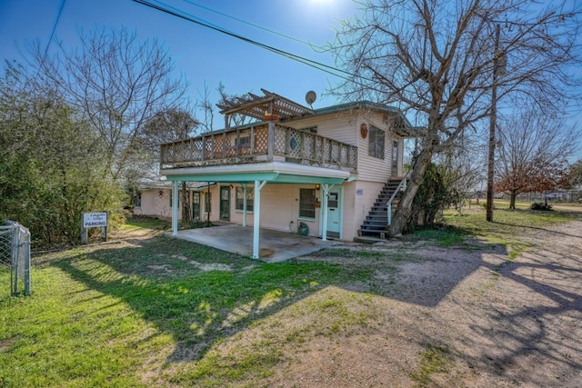 201 Lakewood Dr, Burnet, TX 78611 - rear view of house featuring a patio area, a wooden deck, a yard, and stairway