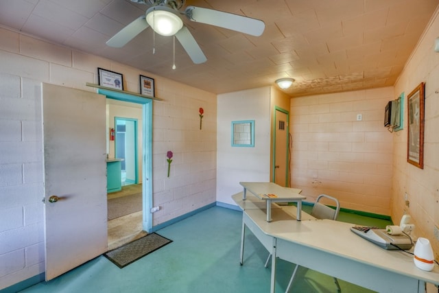 201 Lakewood Dr, Burnet, TX 78611 - office area featuring concrete block wall, a ceiling fan, and finished concrete floors