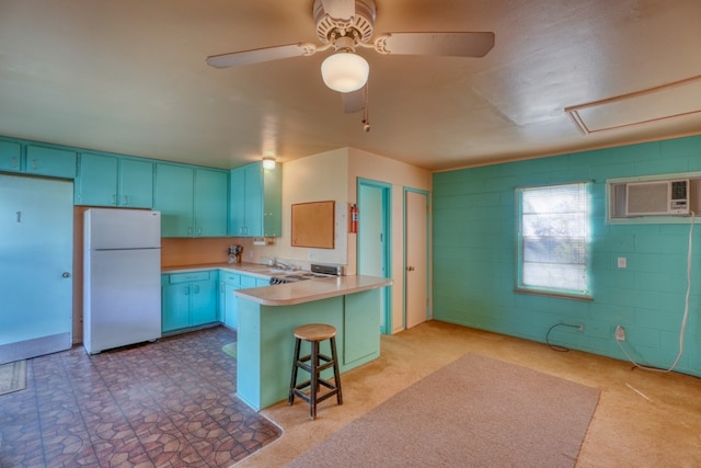 201 Lakewood Dr, Burnet, TX 78611 - kitchen with freestanding refrigerator, blue cabinetry, a peninsula, and a kitchen breakfast bar