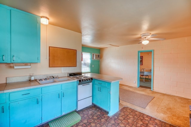 201 Lakewood Dr, Burnet, TX 78611 - kitchen featuring white range oven, blue cabinetry, a peninsula, ceiling fan, and light countertops