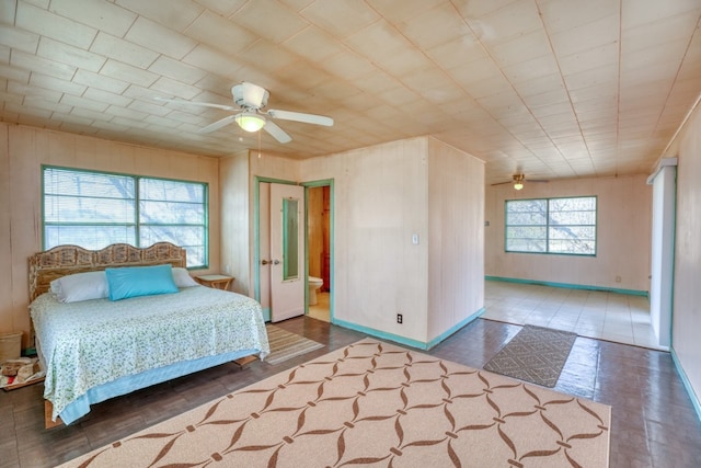201 Lakewood Dr, Burnet, TX 78611 - bedroom with ceiling fan and wooden walls