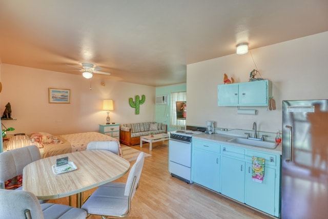 201 Lakewood Dr, Burnet, TX 78611 - kitchen featuring refrigerator, electric stove, light countertops, a ceiling fan, and light wood-style flooring