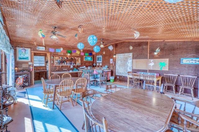 201 Lakewood Dr, Burnet, TX 78611 - dining space featuring ceiling fan and wooden walls
