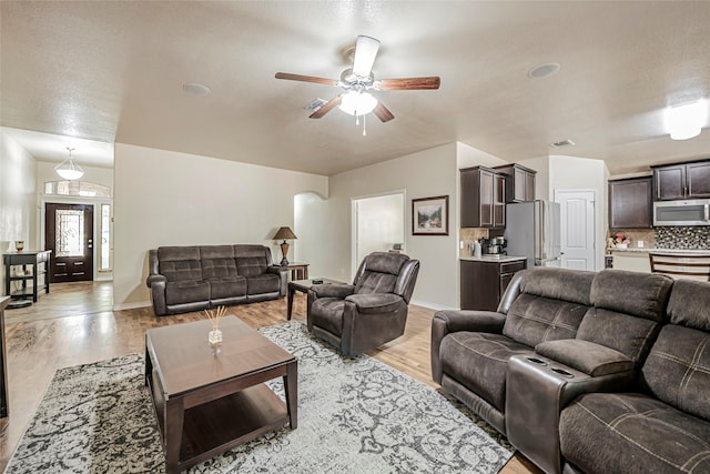 living room featuring ceiling fan and light wood-type flooring