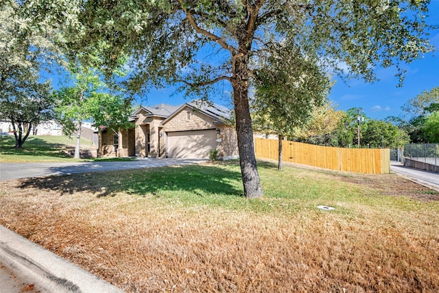 view of front of house with a front yard and a garage