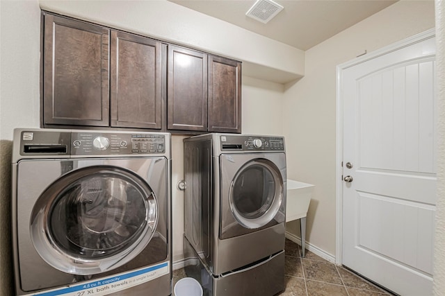 washroom featuring cabinets, light tile patterned flooring, and separate washer and dryer