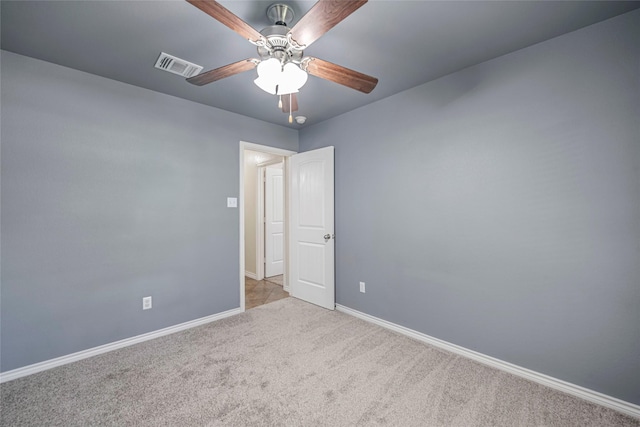 carpeted spare room featuring ceiling fan