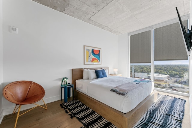 48 E Ave Unit 1405, Austin, TX 78701 - bedroom with wood finished floors and a wall of windows