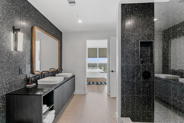 bathroom with vanity and tile walls