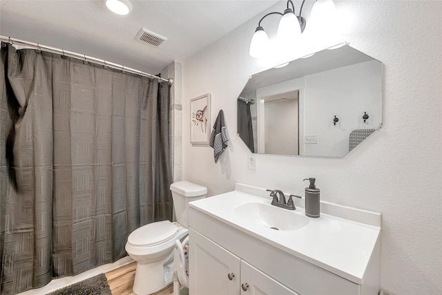 bathroom featuring a shower with shower curtain, vanity, toilet, and wood-type flooring