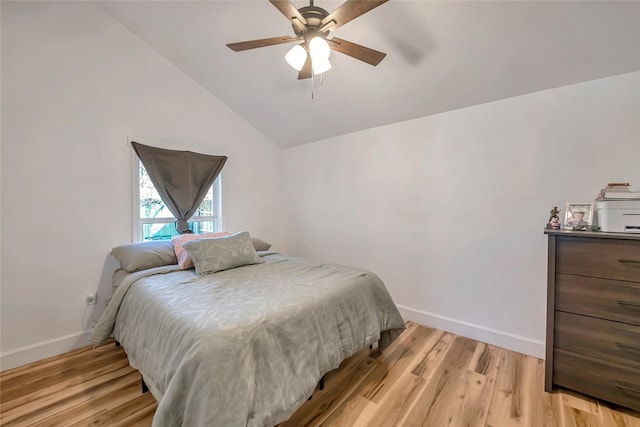 bedroom featuring ceiling fan, light hardwood / wood-style floors, and vaulted ceiling